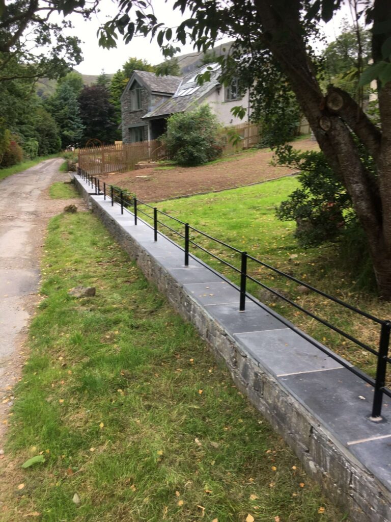 Estate style wall top railings fitted along garden wall in Glenridding Lake District