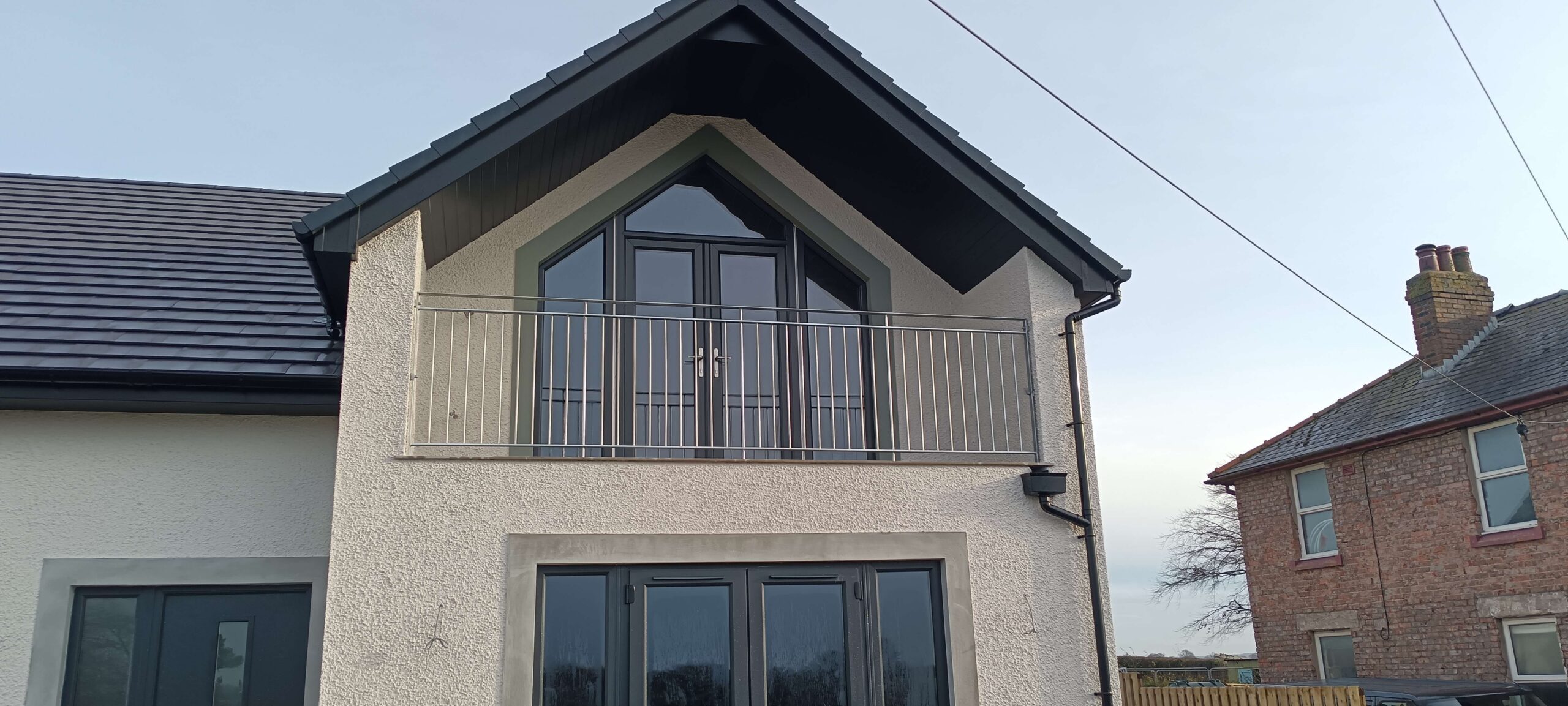 Bespoke steel balcony railing installed on new build house near Thursby Carlisle Cumbria