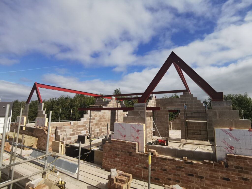 Structural steel double A-frame roof support installed in new build home in Cumbria