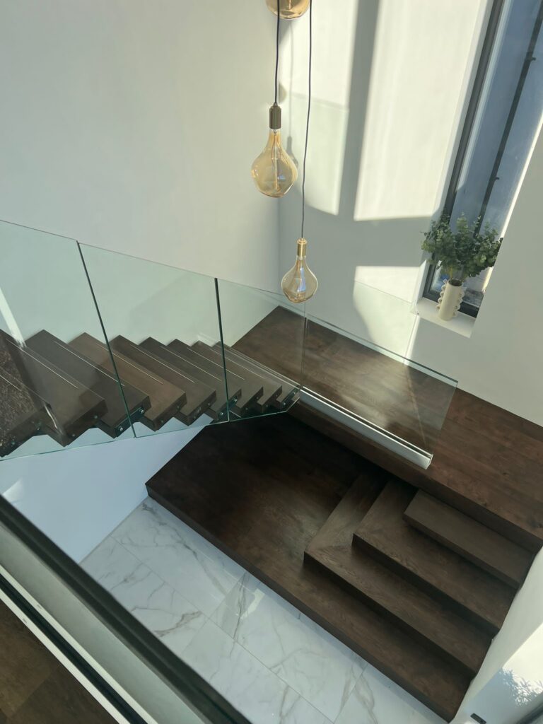 Modern steel spine staircase fitted within open plan interior space in Cumbria home