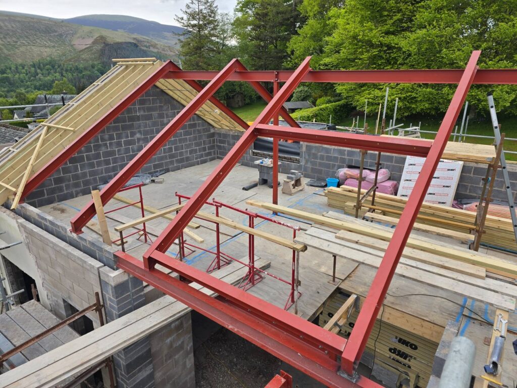 Structural steel wall top frame and glazing support steelwork during installation in the Lake District